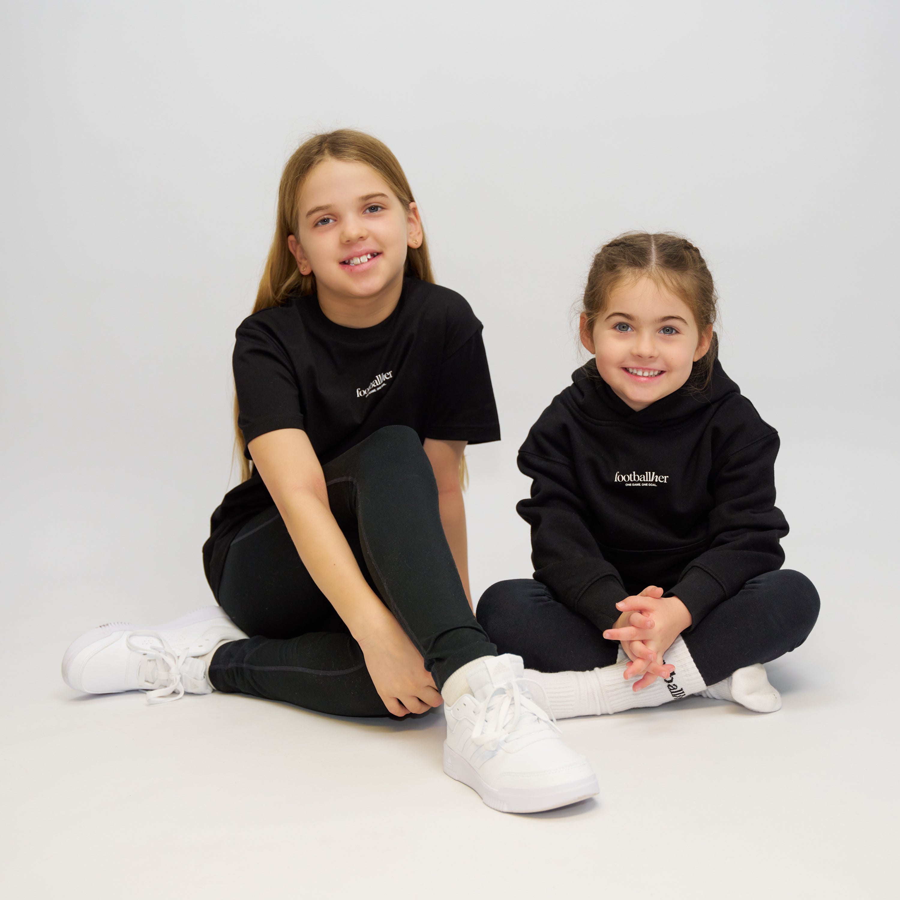 2 girl footballers modelling the off field products.