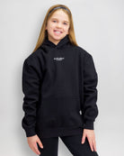 The front of the Girl's Footballher Classic Hoodie on an older girl.